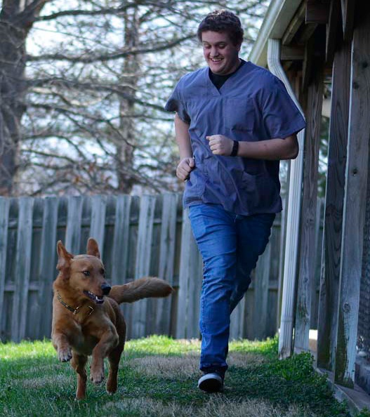 A man and his dog are running