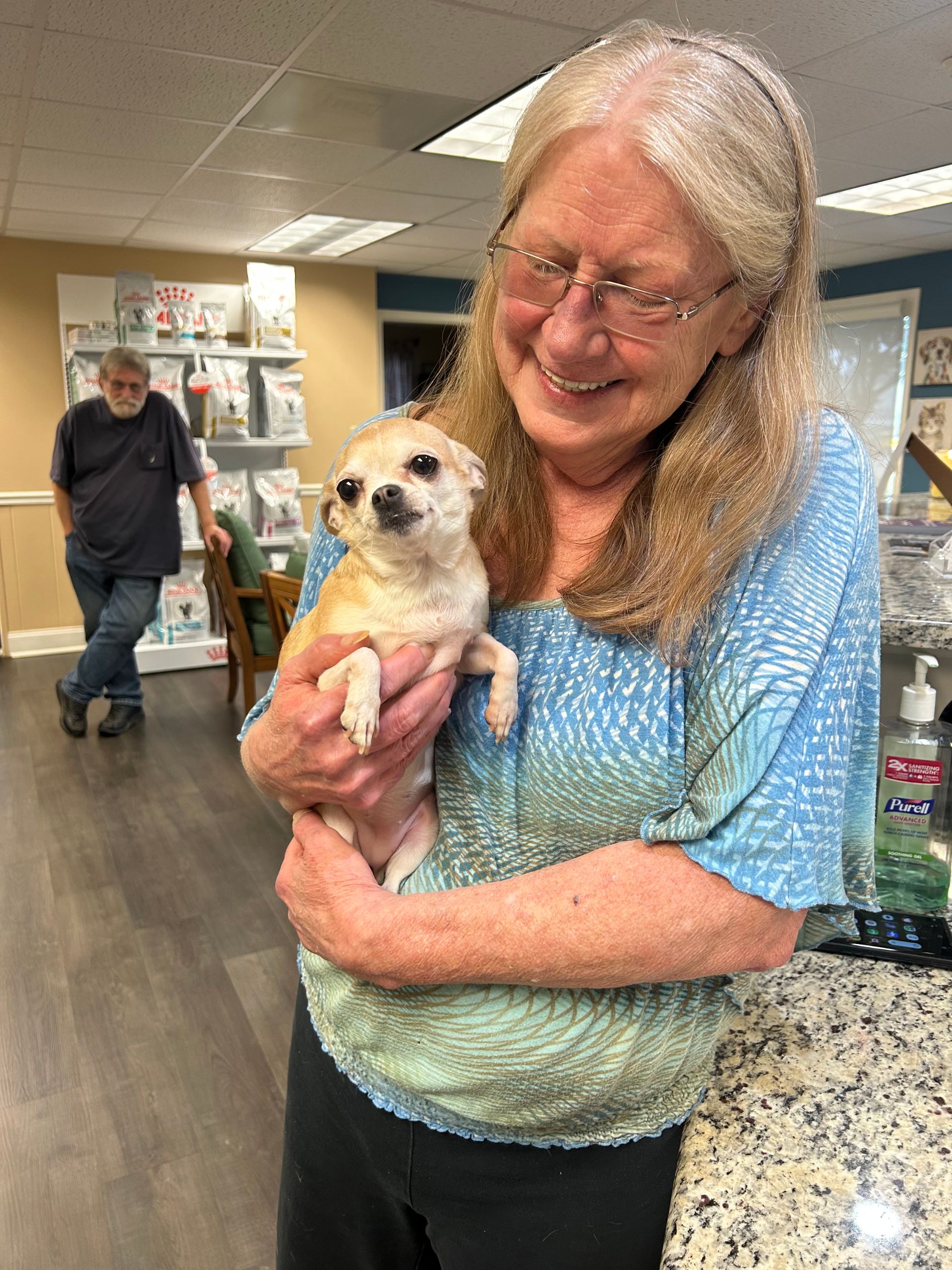 a lady holding a puppy